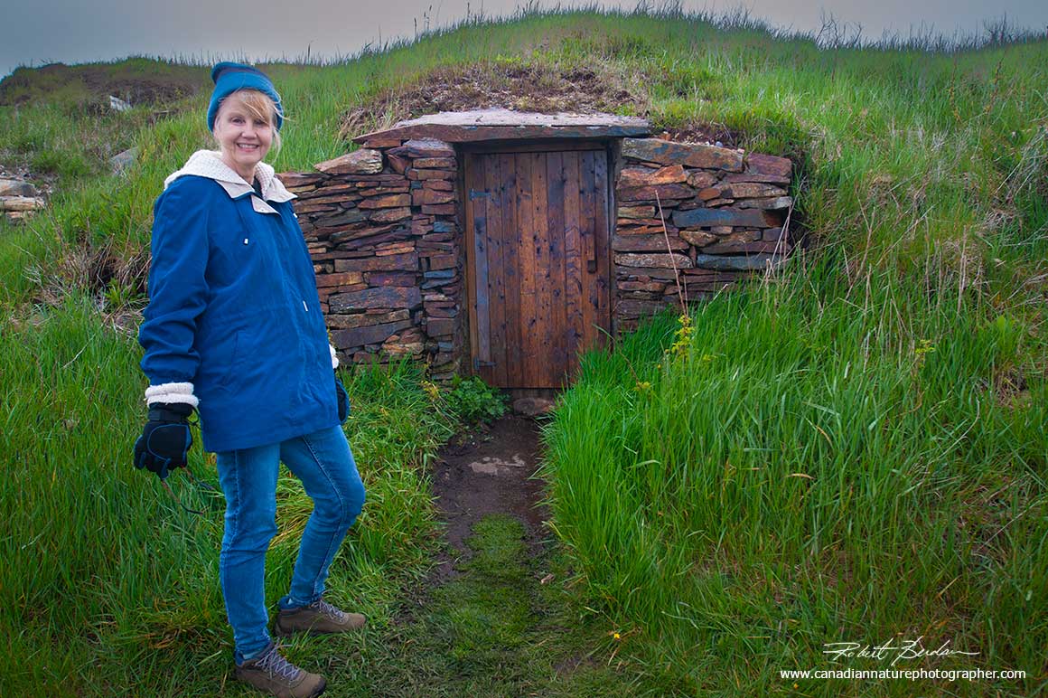 Donna Berdan next to a root cellar in Elliston, Newfoundland by Robert Berdan ©