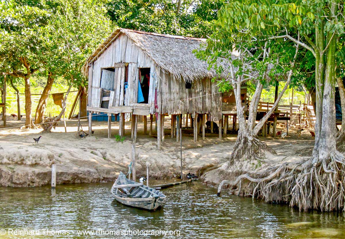Typical modest home of the river dwellers in the Amazon by Reinhard Thomas ©