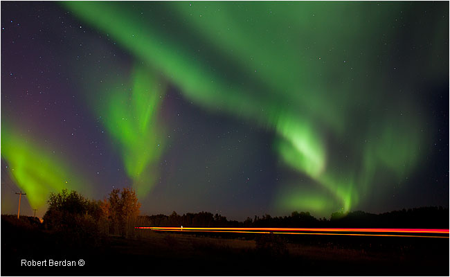 Car lights on road in High Level Alberta with Aurora overhead by Robert Berdan ©