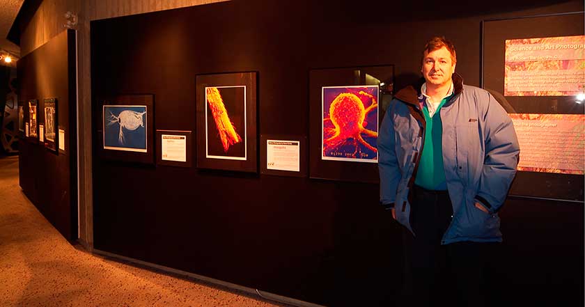 Robert Berdan in front of Science photography exhibit photo by Rinus Borgsteed