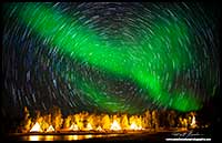 Aurora Borealis and star trails over Aurora village Yellowknife, NT by Robert Berdan