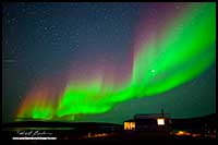 Aurora Borealis over Peterson's Point Lake lodge cabin by Robert Berdan