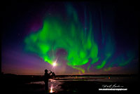 Saxophone player in front of Aurora Borealis over Yellowknife Bay by Robert Berdan