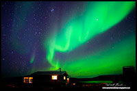 Aurora Borealis over Point Lake cabin in the Northwest Territories by Robert Berdan