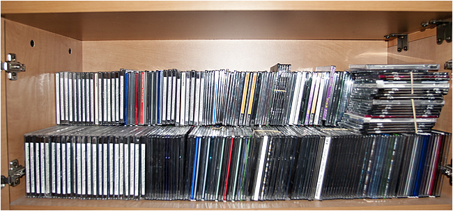 Shelf of CDs and DVDs used to back up digital photographs by Robert Berdan ©
